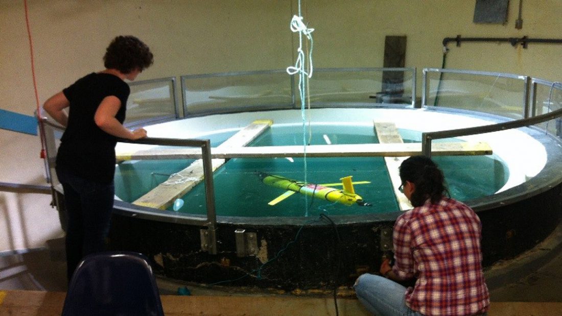 Graduate students Gennavieve Ruckdeschel and Tara Howatt submerge the glider into a 30 m deep seawater tank at Dalhousie to prepare the echosounder sensor for measuring zooplankton at sea.