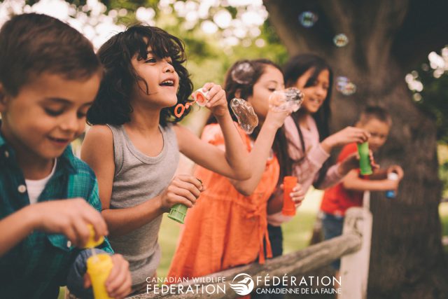 kids outside playing bubbles