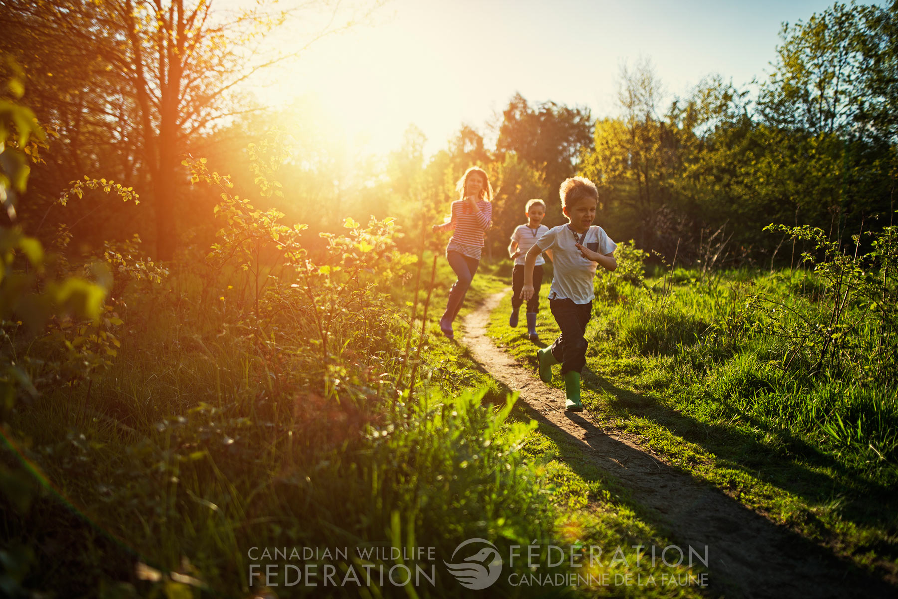 kids running outside dusk field