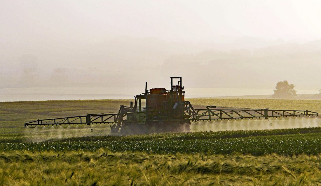 spraying a field farm