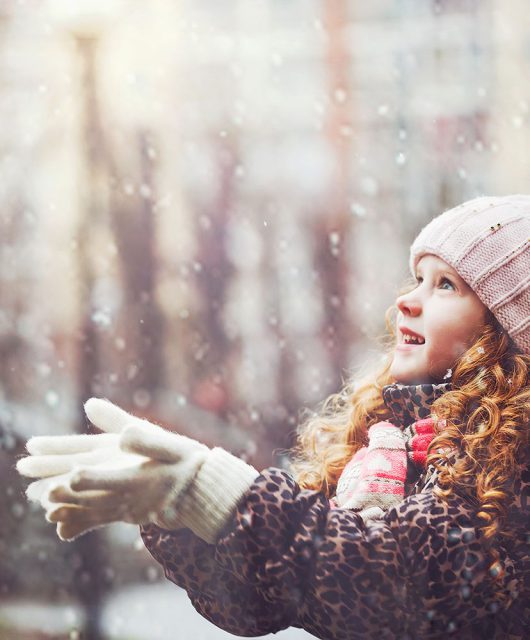 girl in the snow in an urban area