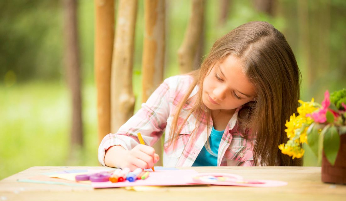 girl colouring outside