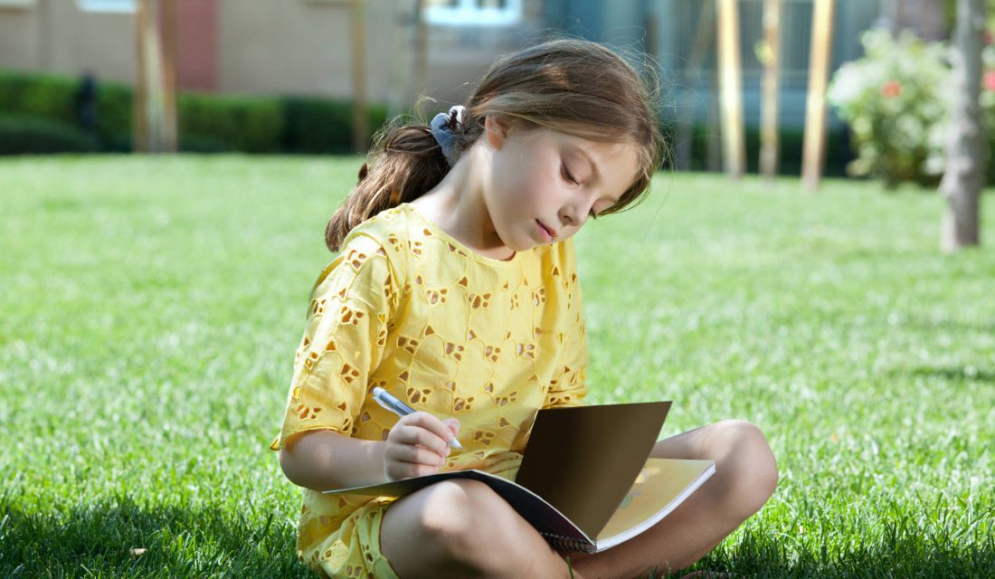 child journaling outside