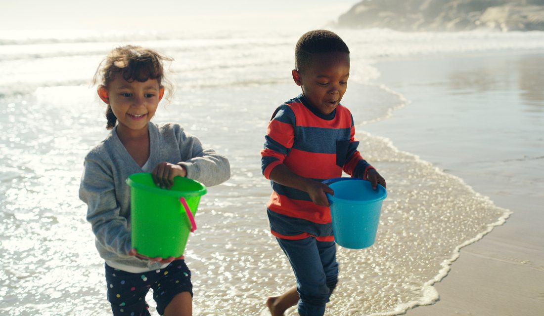 child at the beach playing