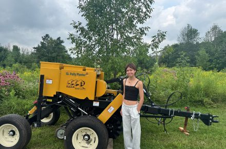 Contest winner Lily unveiling the new seed drill, Polly Planter